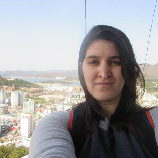 A picture of me on a mountain with a city in the background